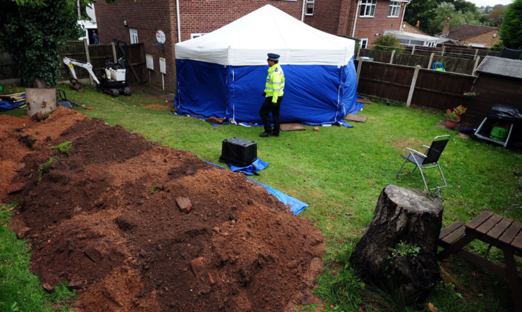 A police tent in the garden of the house near Mansfield where the remains of two people have been found.