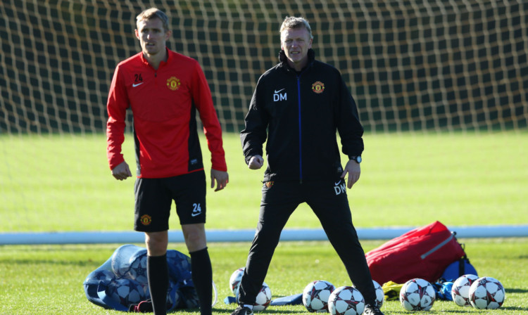 David Moyes looks on as Darren Fletcher resumes training for Manchester United.