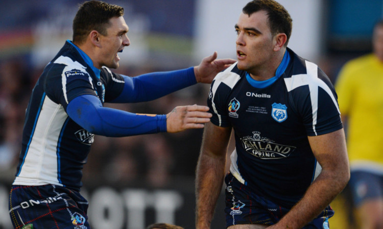 Kane Linnett celebrates his try with Danny Brough during Scotlands draw with Italy at Derwent Park on Sunday.
