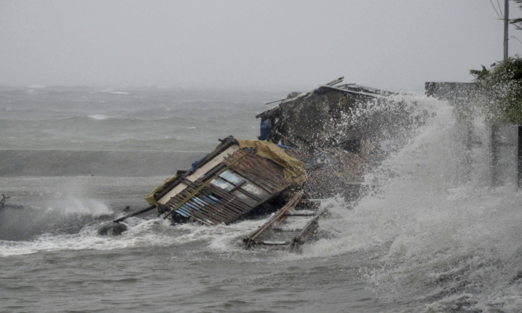 A house is engulfed by the storm surge brought about by powerful typhoon Haiyan that hit Legazpi city, Albay province.