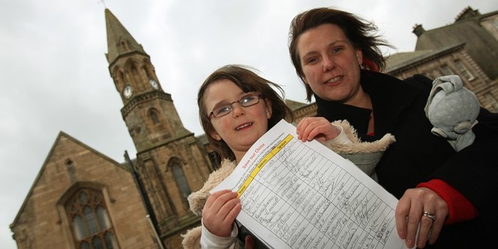 Town Clock, Burntisland.  'Save Our Chime' petition.  Member of the Community Council, and Landlady of The Star pub, Morag Douglas with her daughter Alison, with the petition, and the clock tower in the background.