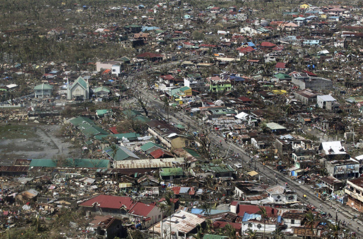 More than 10,000 people are believed to have died after Typhoon Haiyan struck the six central Philippine islands on Friday. Aid agencies from across the world are racing to help in what is being described as one of the strongest storms ever recorded. This aerial shot of the province of Leyte shows how the typhoon has flattened homes.
