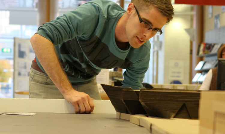 Masters Architecture student Craig Sutherland puts the finishing touches to the model of Dundee Waterfront.