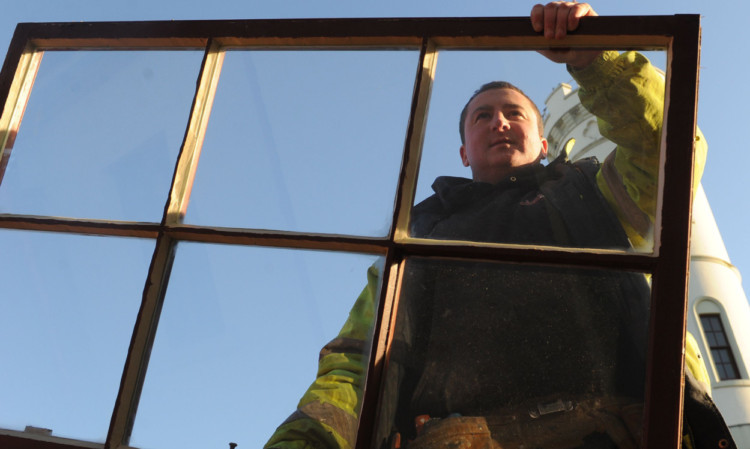 Richard Ferguson of Logie Building Services repairing a window at the Signal Tower.