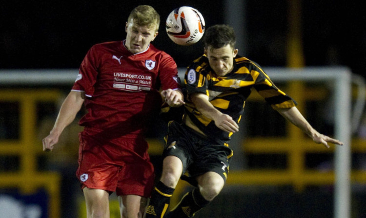 Raith's Paul Watson goes head to head with Kevin Cawley.