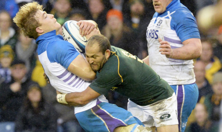 David Denton feels the force of a Fourie du Preez tackle in Sunday's game against South Africa.