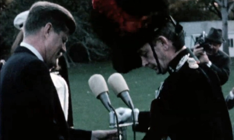 President Kennedy is presented with a gift by Major Wingate Gray, leader of the Black Watch, outside the White House. Nine days later the band would return to play at JFK's funeral.