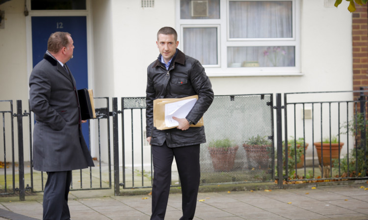 Detectives conduct house-to-house interviews in a South London block of flats that is being investigated in connection with an alleged slavery case.