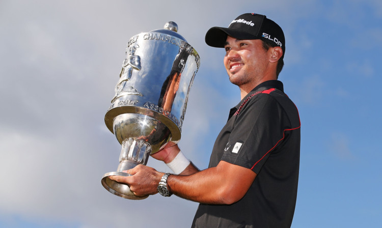 Jason Day poses with the trophy.