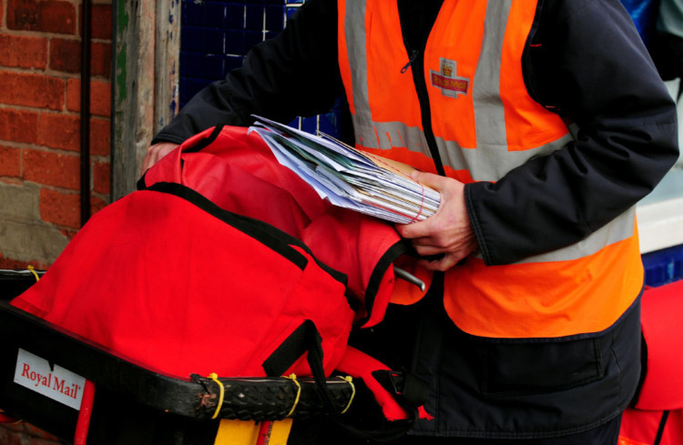 Postal workers deliver mail in Beeston, Nottingham on the second day of a two day nationwide strike by members of the Communication Workers Union.