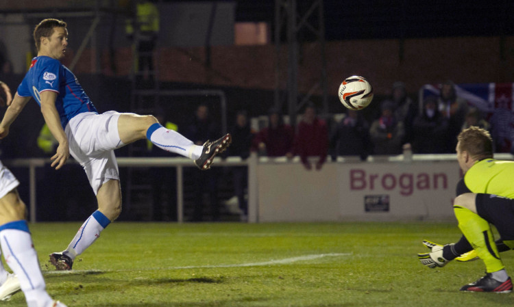 Jon Daly (left) directs the ball into the net to give Rangers an early lead at Gayfield.