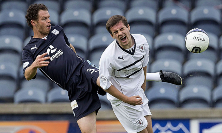 Matt Lockwood challenges Raiths Lewis Vaughan during the league meeting at Starks Park in August.