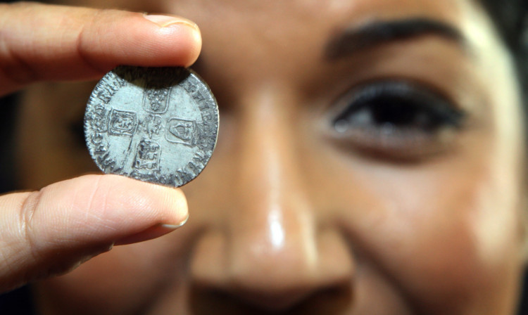 Research and Activities Assistant at Dunfermline Museum and Art Gallery project Shahana Khaliq with a shilling from 1697 - from the reign of William III, found on the spoil heap at Dunfermline library.