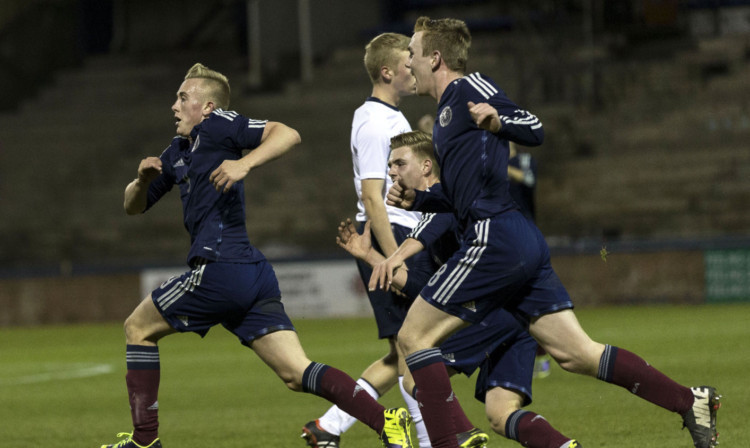 Calvin Miller, left, races off to celebrate after opening the scoring for Scotland.