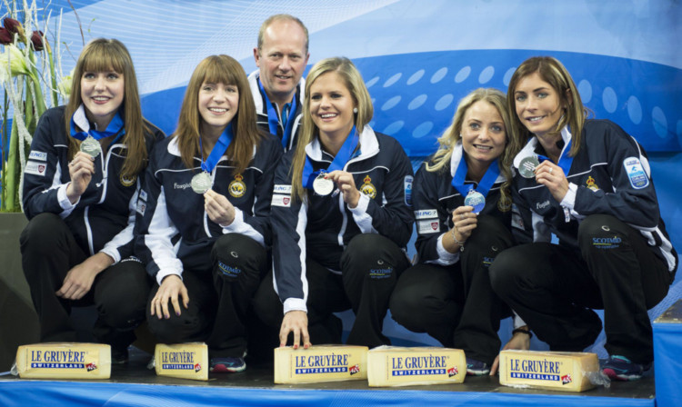 Hard cheese: From left, Lauren Gray, Claire Hamilton, coach David Hay, Vicki Adams, Anna Sloan and Eve Muirhead of team Scotland display their silver medals.