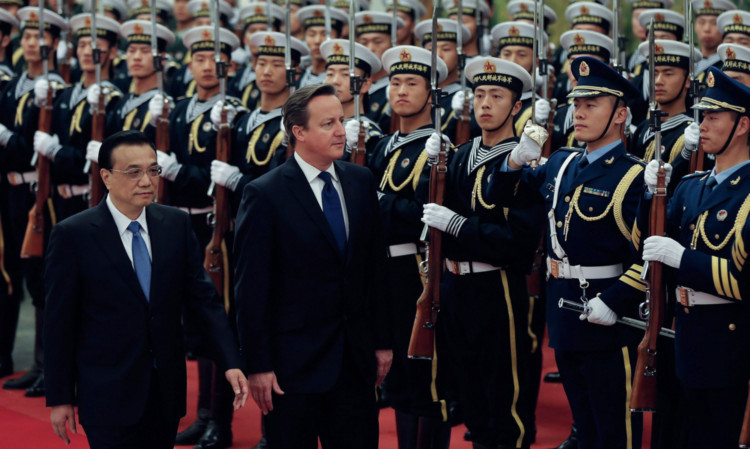 Chinese Premier Li Keqiang accompanies David Cameron to view an honour guard during a welcoming ceremony inside the Great Hall of the People.
