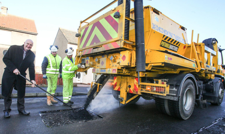 Mr Crooks in St Kilda Crescent, Kirkcaldy, with the pothole-busters.