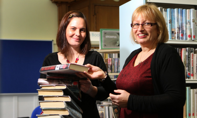 Louise Reid, Library assistant and Aurora Mackintosh, Senior Library Assistant putting the finishing touches to the newly refurbished Kirriemuir library.