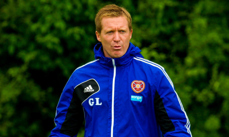 Hearts manager Gary Locke keeps an eye on training.