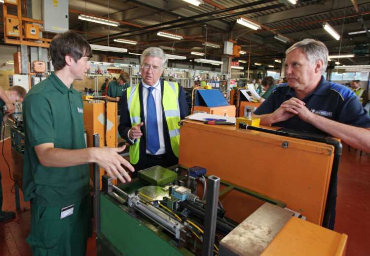 Business and Energy Minister Michael Fallon on a visit to Michelin in Dundee with apprentice Bradley Rollo, left, and instructor Graham Douglas, right.