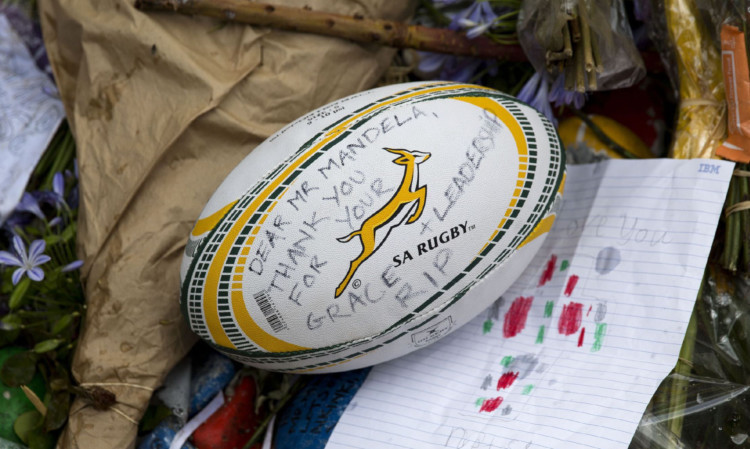 A rugby ball lies amongst tributes outside Nelson Mandela's former home. Mandela knew sport and politics could mix with positive results for his country.