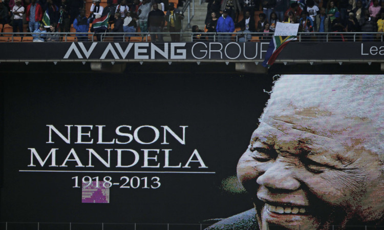 An image of Nelson Mandela is projected on a screen at the FNB Stadium ahead of the memorial service.