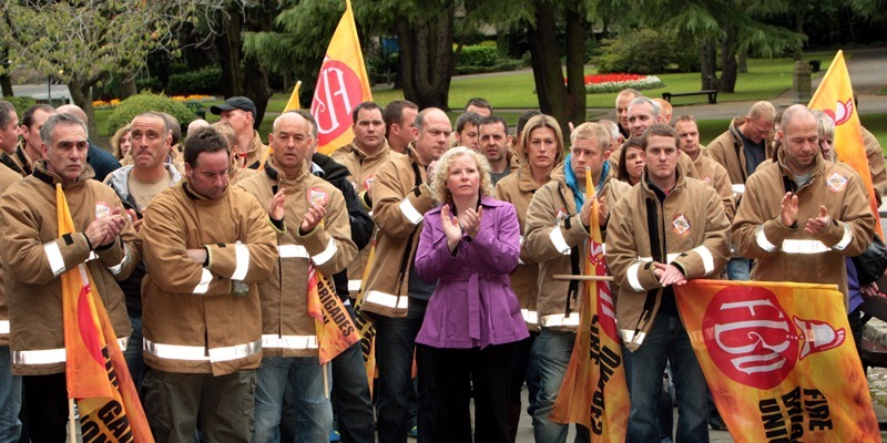 John Stevenson, Courier, 30/08/11. Fife, Kirkcaldy, Adam Smith Theatre, pic shows members of the Fire Brigades Union as they protest outside the theatre over budget cuts.Claire Baker local MSP is pictured here centre.