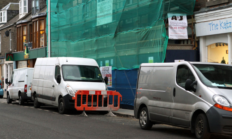 Contractors vans parked on Gray Street.