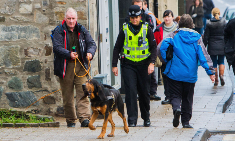 Sgt Caroline MacNaughton and a dog and handler from the Search And Rescue Dog Association joining the search in Pitlochry on Thursday.