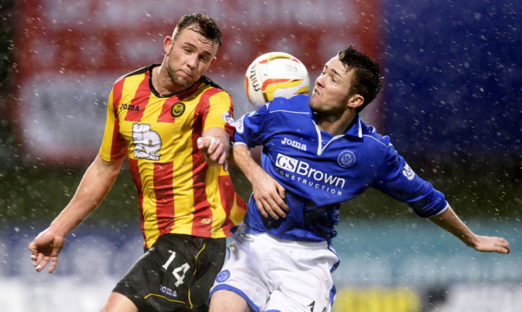 Gwion Edwards battling for possession in the rain on Saturday.