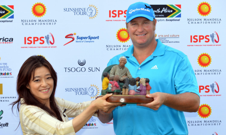 Dawie Van Der Walt is presented with the trophy.