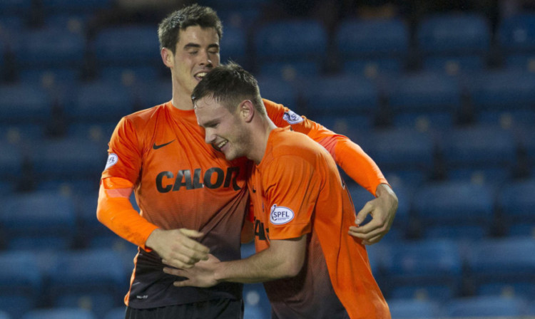 Keith Watson is congratulated by Brian Graham after opening the scoring.