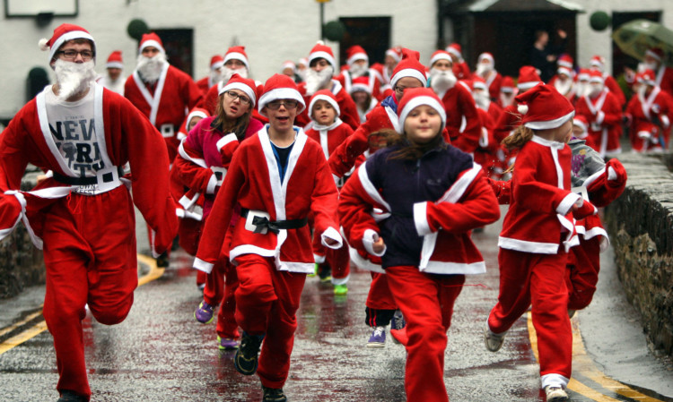 Kris Miller, Courier, 14/12/13. Picture today at the Killin Santa Dash where around 150 Santas ran the 2km course to raise money for local schools. Race organiser Pete Waugh (07786 558861) hopes it will become an annual event and grow from strength to strength. Pic shows Santas at the start of the race.