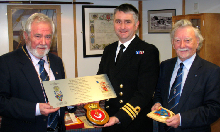 Jim Shearer and Alex Coupar gave Commander Stride a plaque.