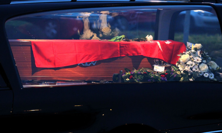 The hearse carrying the coffin of Joe Cusker arrives for his funeral at South Lanarkshire Crematorium.