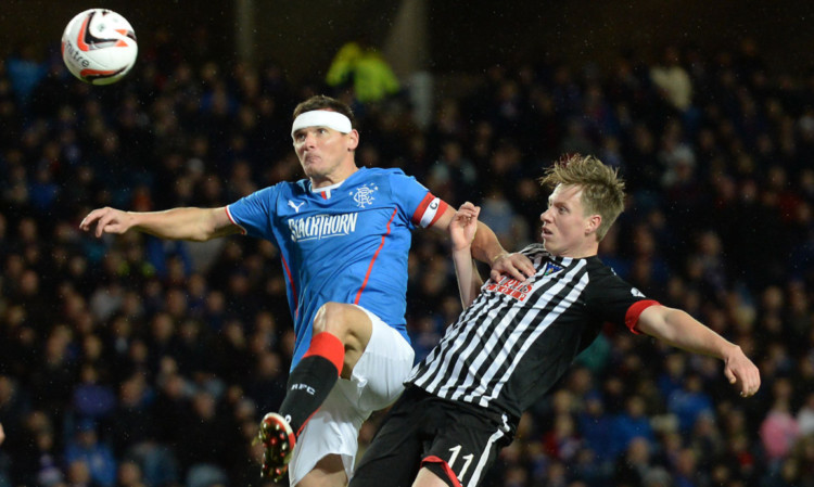 Jordan Moore (right) battles with Rangers midfielder Lee McCulloch.