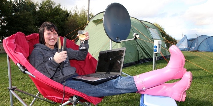 Steve MacDougall, Courier, Noah's Ark Caravan Park, Western Edge, Perth. Picture to accompany story about holiday Glamping! Pictured, Sandra Allan (from Shotts) relaxes by her tent, complete with satellite dish, laptop, hair-straighters and a glass of wine.