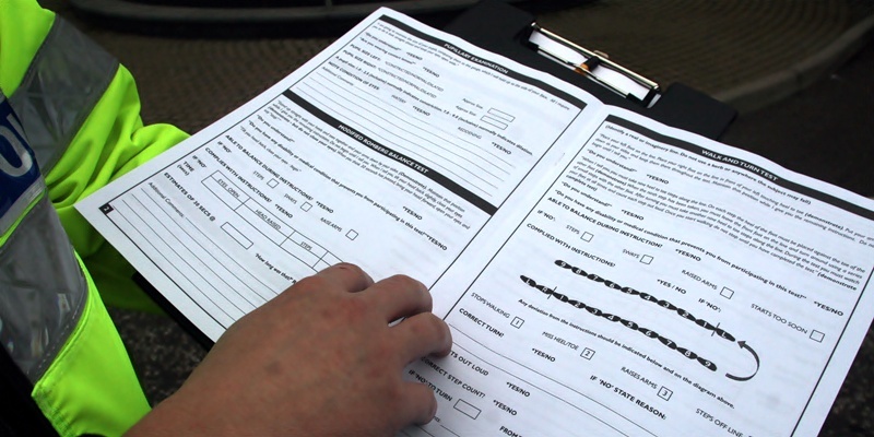 Tayside Police Constables Stewart Coupland and Gordon Britton demonstrate the kind of impairment test they may carry out on motorists they suspect of driving under the influence of drugs.