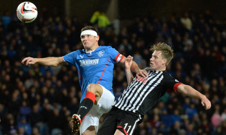 Jordan Moore challenges with Rangers midfielder Lee McCulloch.