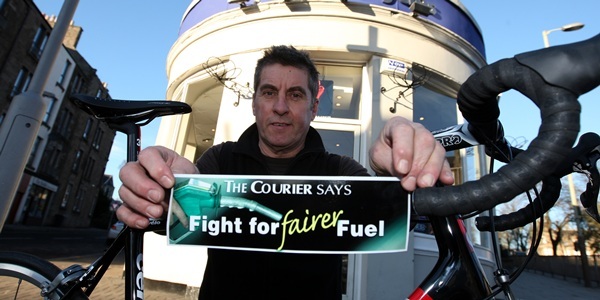 Steve MacDougall, Courier, Nicholson's Cycles, Forfar Road, Dundee. Pictured, Bryan Williams (of Nicholson's Cycles) with the Fairer Fuel sticker.