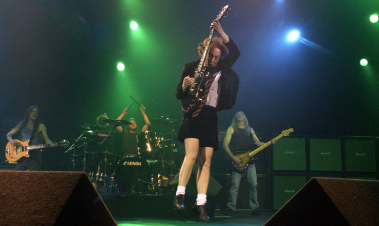 Lead guitarist Angus Young performing live.