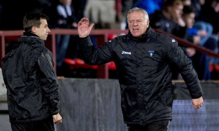 An animated Jim Jefferies (right) with assistant Neil McCann during Monday's match.
