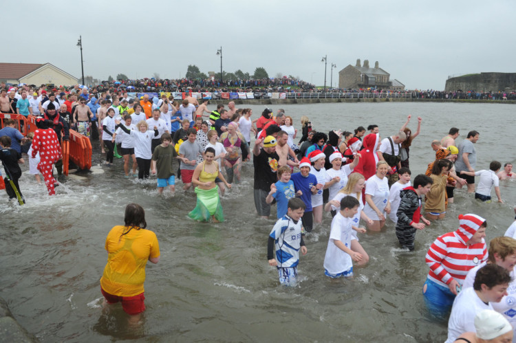 Around 300 people, many of them in fancy dress, braved the 2014 Broughty Ferry New Year Dook despite an extremely high tide and near-freezing temperature. The costumes on display were the usual wacky mix, featuring everything from Santa and an elf to a fair few men in dresses, including what appeared to be a fairy princess.