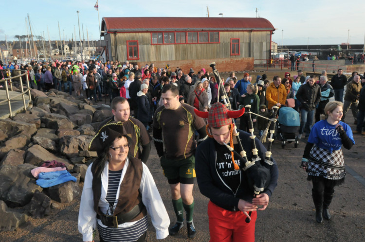 Arbroaths 2014 New Year Dook was held at noon, with a minor, weather-forced switch from the lifeboat shed to the new slip just a couple of hundred yards west of the station. The event raises money for Cancer Research UK and organiser Alana Loudon said there was no doubt the turnout was the best yet.