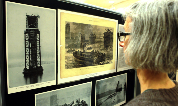 A member of the public studies some of the works on display at the exhibition.