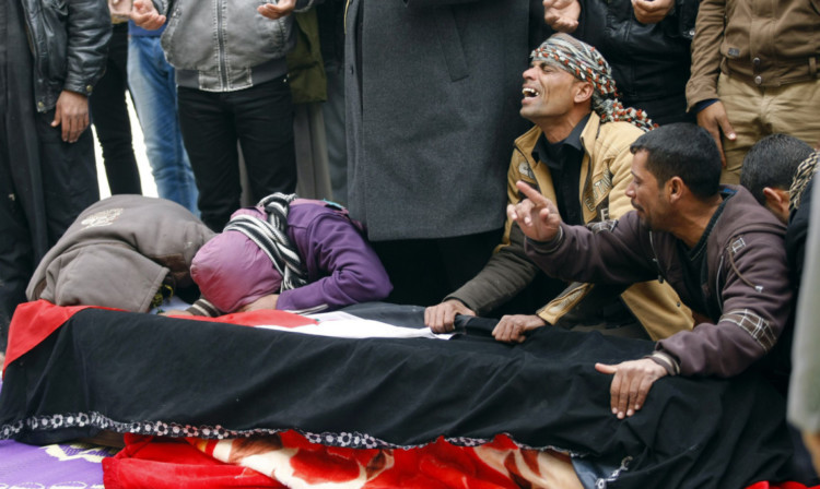Mourners grieve over the coffin of Iraqi soldier Layth Ahmed, who was killed in Ramadi.