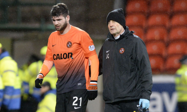 Nadir Ciftci (left) is helped off the pitch on Sunday.