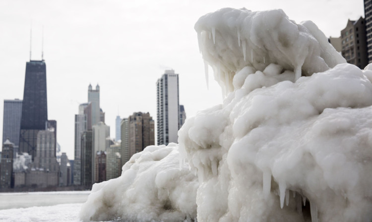 The Chicago skyline behind a large chunk of ice near North Avenue Beac.