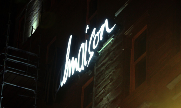 The half-illuminated sign on the Malmaison hotel.