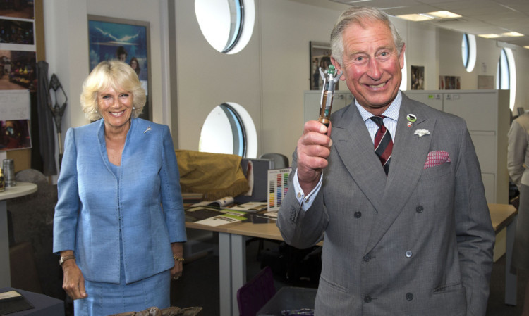 The Prince of Wales tried out a sonic screwdriver when he and the Duchess of Cornwall visited the set of Doctor Who.